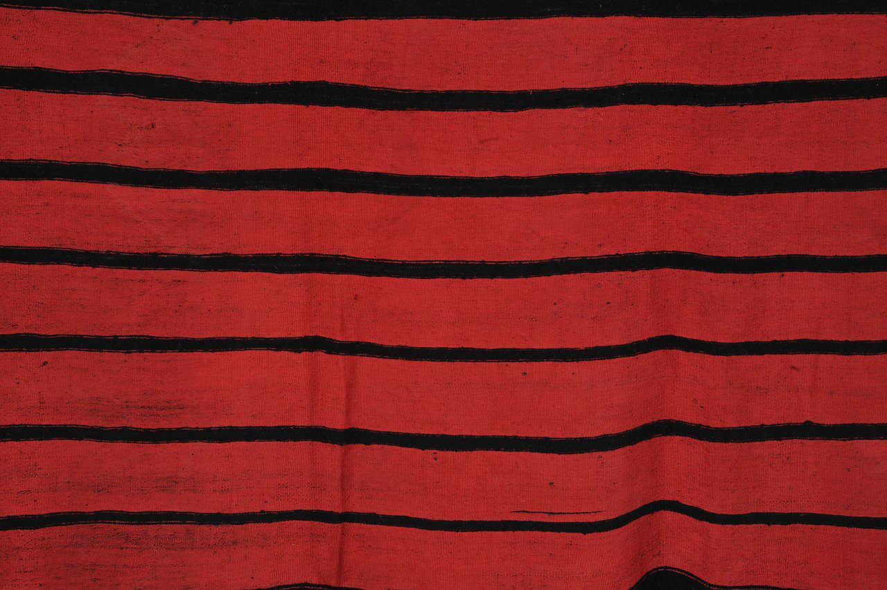 A strikingly visual shawl composed of alternating rows of horizontal stripes in undyed dark wool and insect dyed fuchsia red silk. The differing widths of each stripe imparts this textile with a very contemporary look. Shawls of this type are